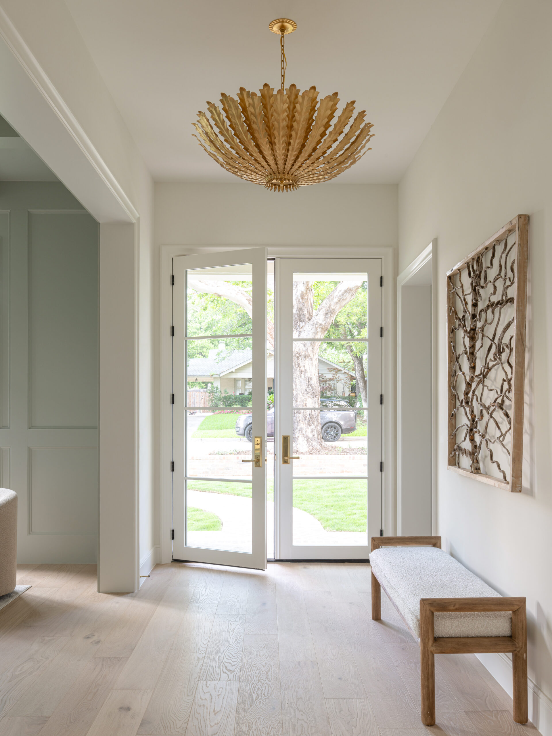 CLASSIC EUROPEAN REVIVAL – Chamberlain Arlington Heights, Lafayette Ave, Fort Worth, TX 76107-1 Foyer with French doors, gold leaf chandelier, and white oak floors — Blue Cypress Design Build, Fort Worth TX
