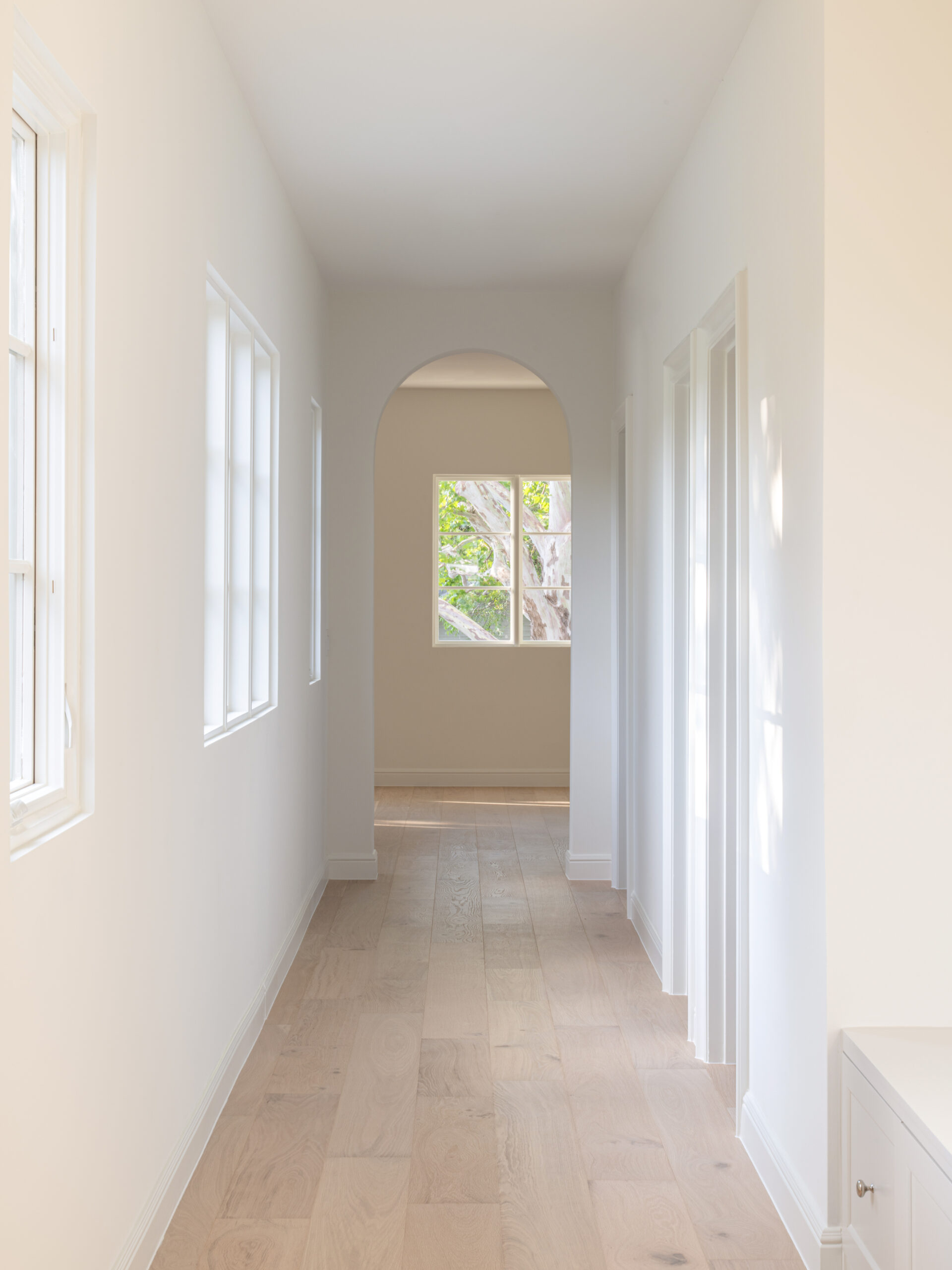 CLASSIC EUROPEAN REVIVAL – Chamberlain Arlington Heights, Lafayette Ave, Fort Worth, TX 76107-32 Sunlit hallway with arched opening and white oak floors — European style remodel, Fort Worth TX