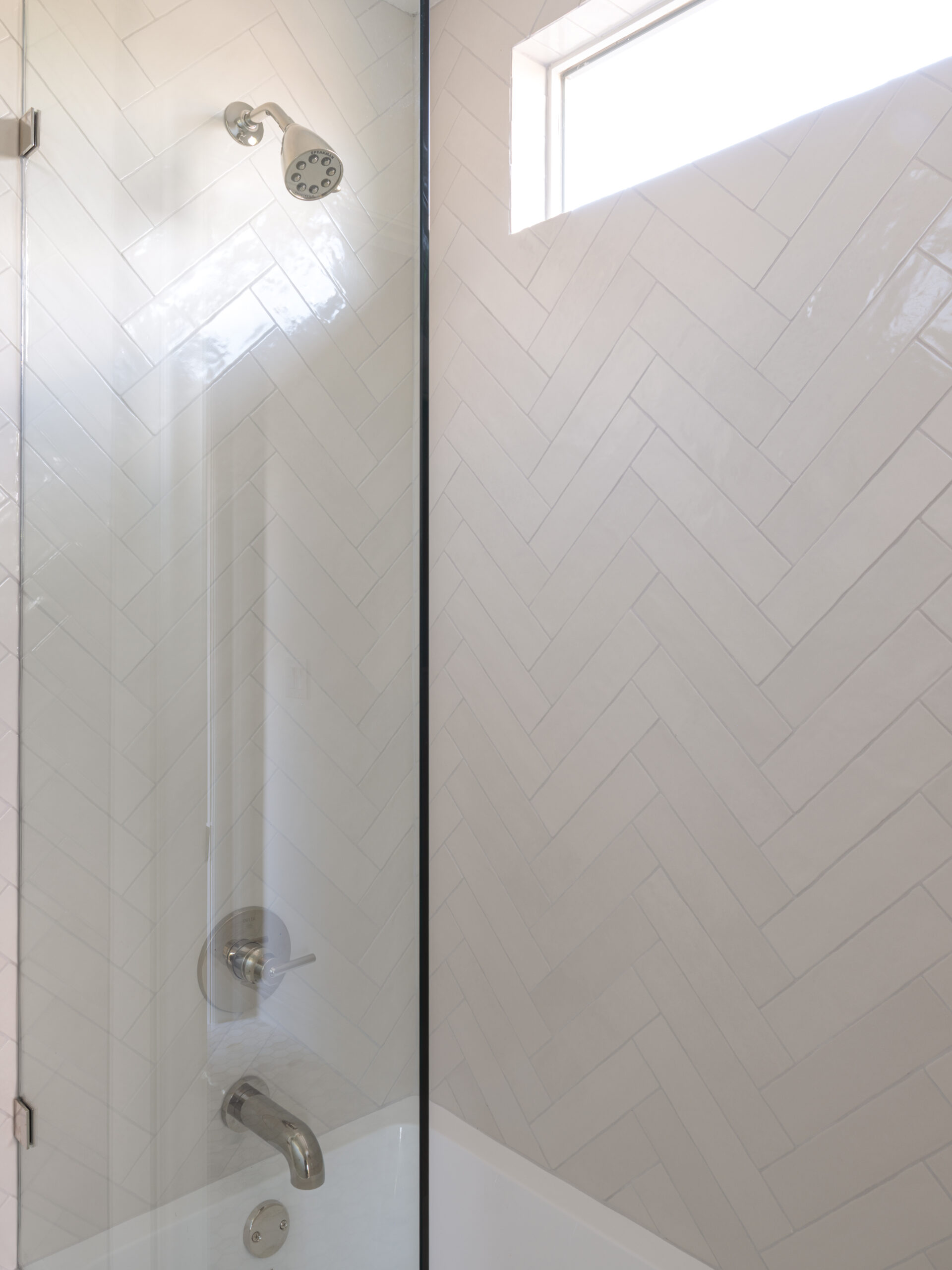 CLASSIC EUROPEAN REVIVAL – Chamberlain Arlington Heights, Lafayette Ave, Fort Worth, TX 76107-34 Herringbone tile shower over tub with glass panel — Blue Cypress Design Build custom remodel, Fort Worth TX
