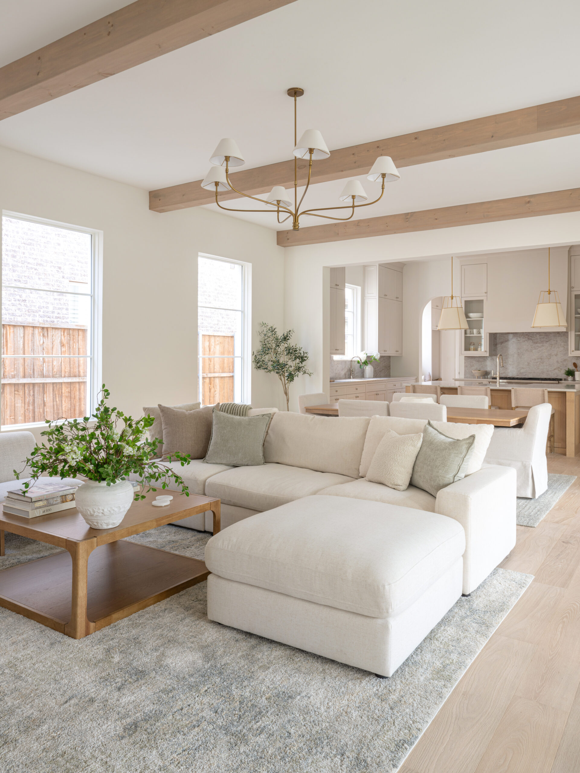 CLASSIC EUROPEAN REVIVAL – Chamberlain Arlington Heights, Lafayette Ave, Fort Worth, TX 76107-4 Open living room with wood beams and brass chandelier in a luxury custom home — Blue Cypress Design Build, Fort Worth TX