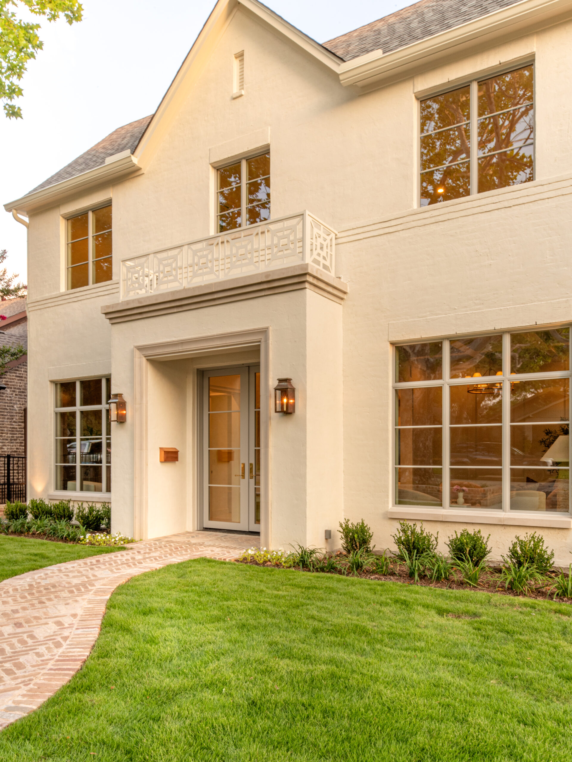 CLASSIC EUROPEAN REVIVAL – Chamberlain Arlington Heights, Lafayette Ave, Fort Worth, TX 76107-48 Front entry at dusk with copper lanterns and decorative balcony railing — Blue Cypress Design Build, Fort Worth TX