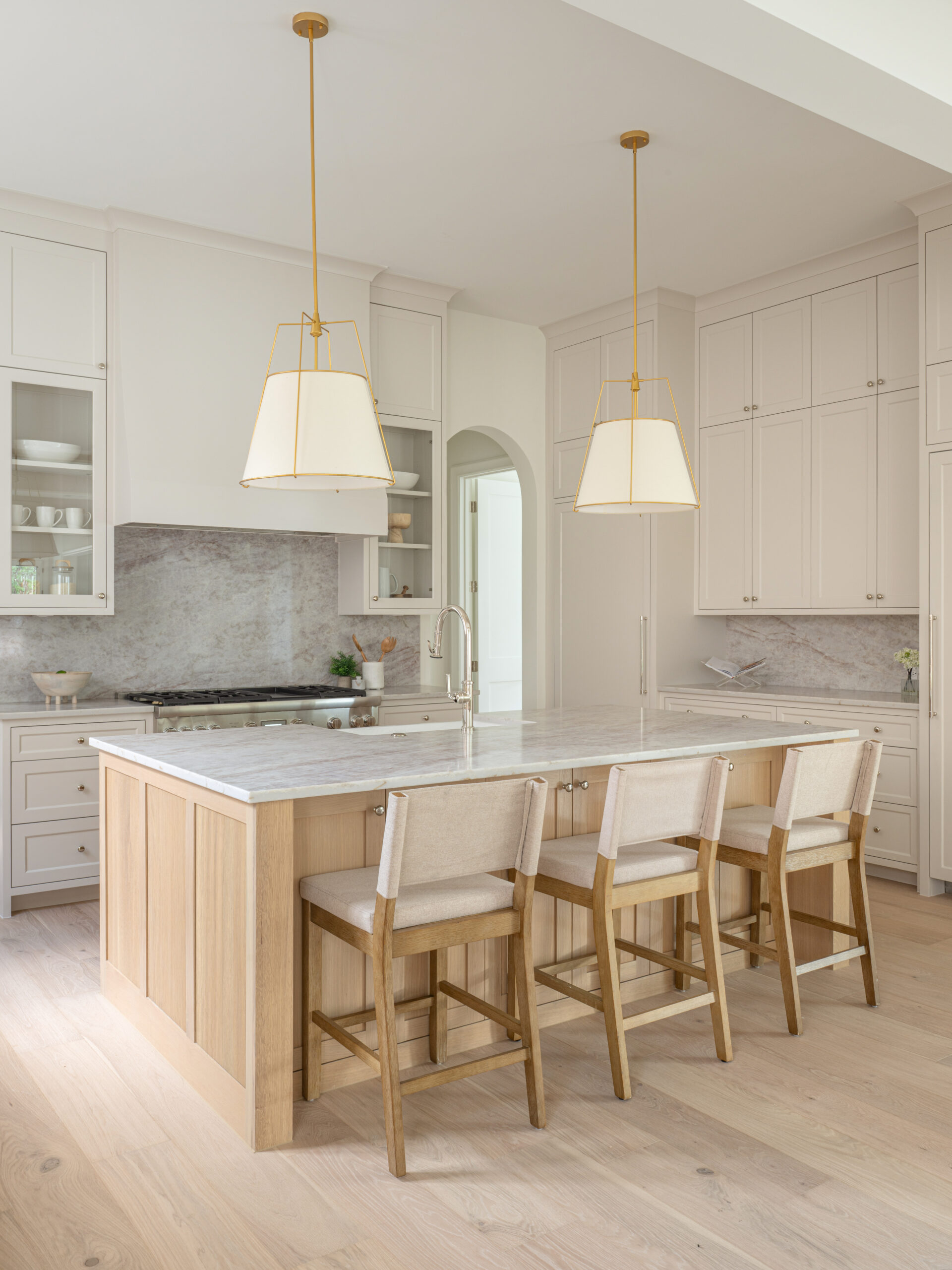 CLASSIC EUROPEAN REVIVAL – Chamberlain Arlington Heights, Lafayette Ave, Fort Worth, TX 76107-8 White oak kitchen island with stone countertop and brass pendants — Blue Cypress Design Build, Fort Worth TX